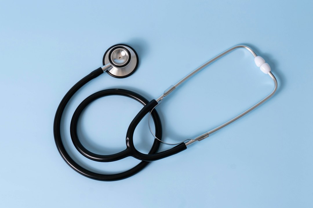A stethoscope on a blue background, symbolizing medical examination.
